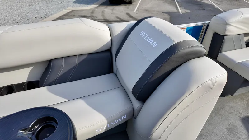 Slide: The Image of 2025 Sylvan MIRAGE 818 CRS boat seats with cup holder, featuring sleek gray upholstery. - 14