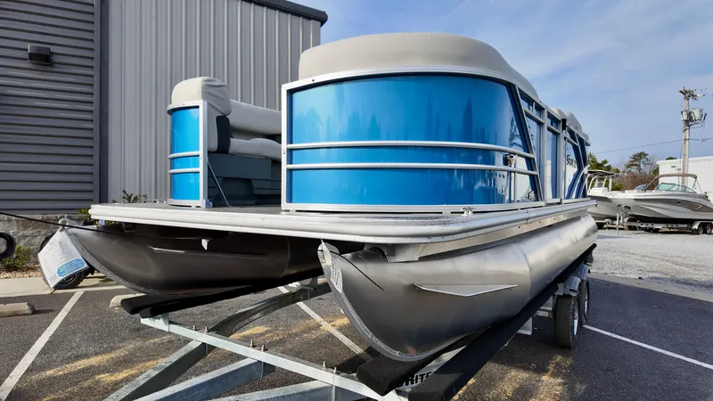 Slide: The Image of 2025 Sylvan MIRAGE 818 CRS pontoon boat with blue panels on a trailer. - 3