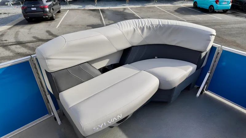 Slide: The Image of 2025 Sylvan MIRAGE 818 CRS boat seating, featuring gray upholstery in a parking lot setting. - 7