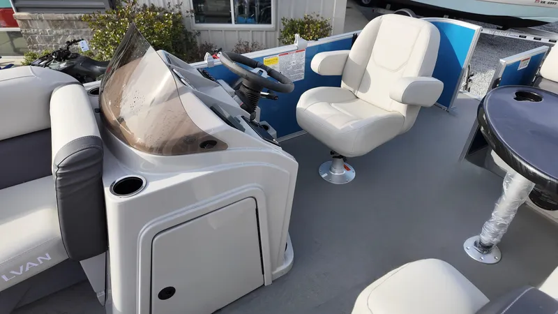 Slide: The Image of 2025 Sylvan MIRAGE 818 CRS boat interior with steering console and seating. - 9