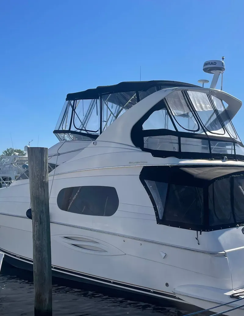Slide: The Image of 2003 Silverton 410 Sport Bridge yacht docked under clear blue sky. - 11
