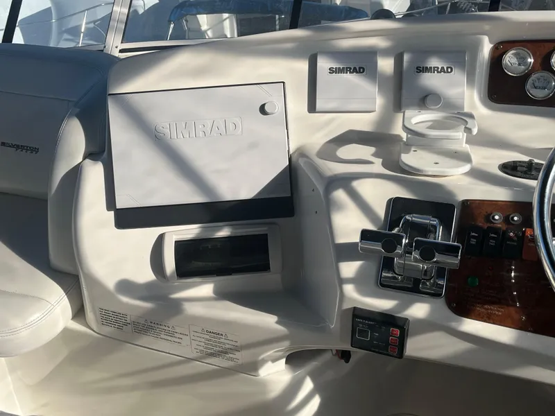 Slide: The Image of Control panel of a 2003 Silverton 410 Sport Bridge with Simrad navigation equipment. - 13