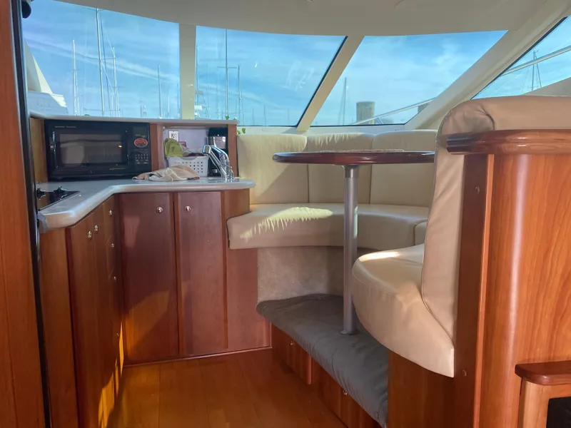 Slide: The Image of Interior of 2003 Silverton 410 Sport Bridge yacht with wood cabinetry and seating area. - 17