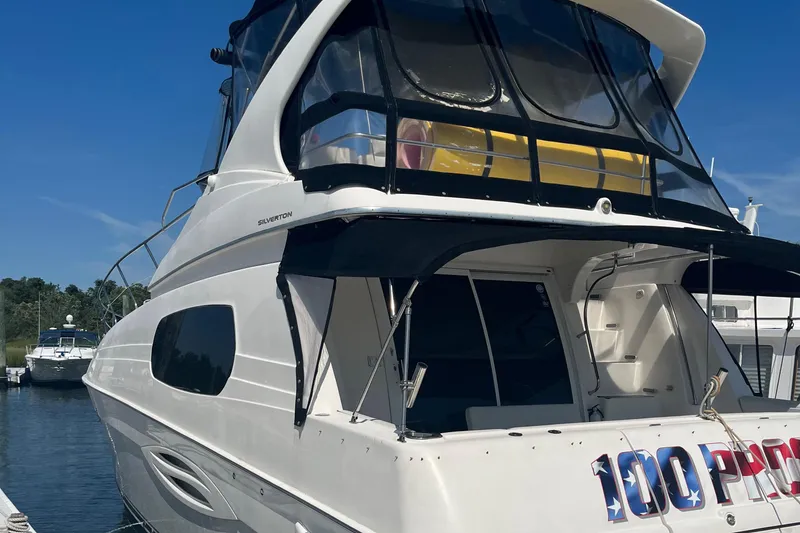 Slide: The Image of 2003 Silverton 410 Sport Bridge yacht docked at marina, rear view. - 18