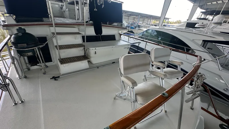 Slide: The Image of 1987 Grand Banks 46 Classic yacht deck with seating and grill in marina. - 13