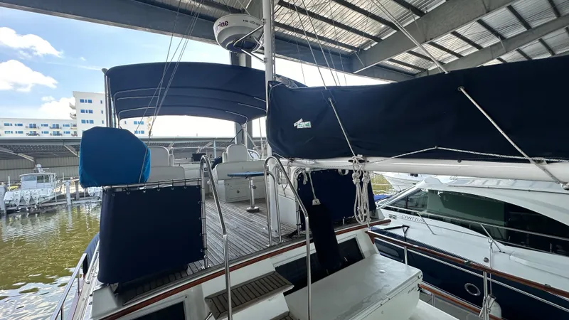 Slide: The Image of 1987 Grand Banks 46 Classic yacht docked under a covered marina. - 14