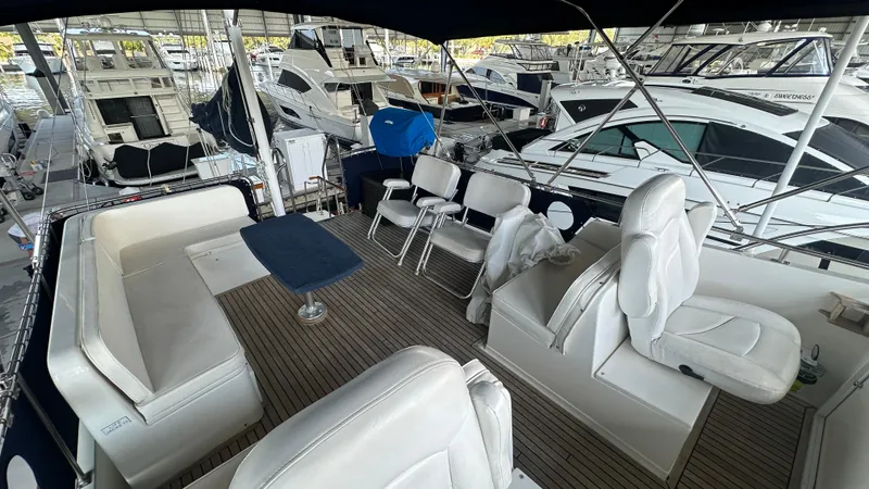 Slide: The Image of Grand Banks 46 Classic 1987 yacht interior with seating and table, docked among other boats. - 17
