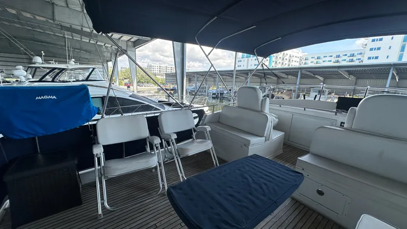 Slide: The Image of 1987 Grand Banks 46 Classic yacht interior with seating and canopy, docked at marina. - 18