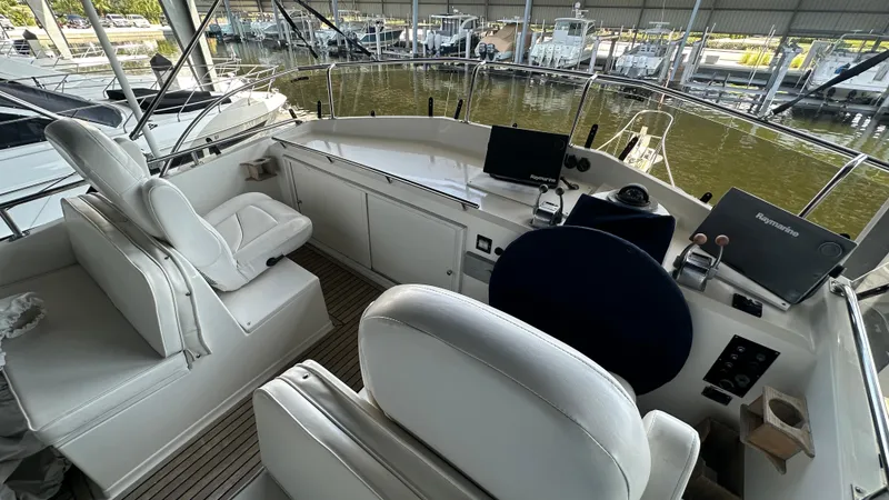 Slide: The Image of Interior view of 1987 Grand Banks 46 Classic yacht helm with white seating. - 19