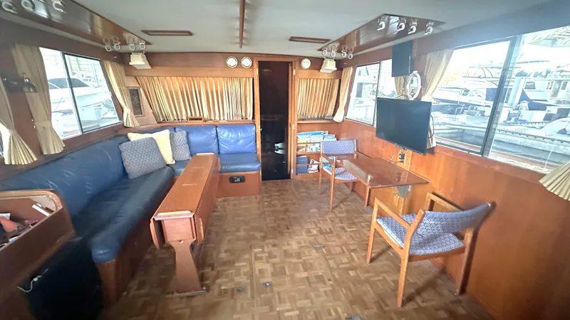 Slide: The Image of Interior of 1987 Grand Banks 46 Classic yacht with wood paneling and blue seating. - 22