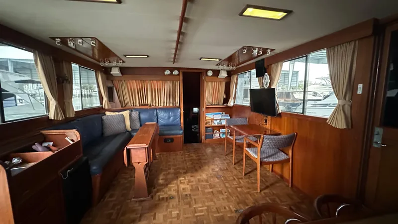 Slide: The Image of Interior of 1987 Grand Banks 46 Classic yacht, featuring wood paneling and comfortable seating. - 24