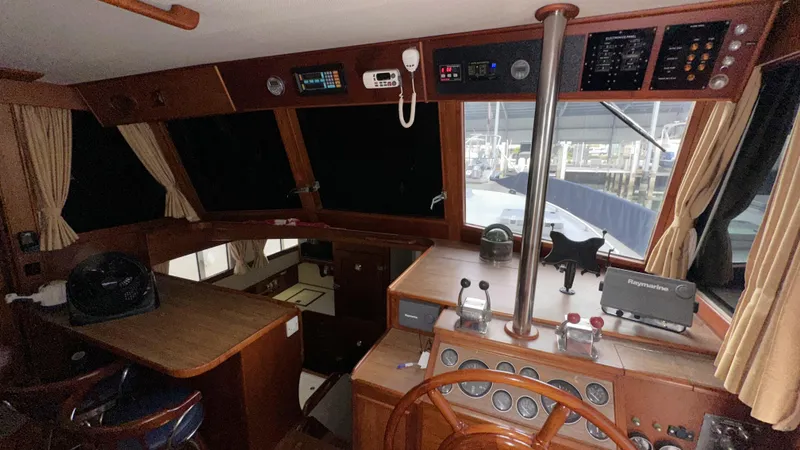 Slide: The Image of 1987 Grand Banks 46 Classic yacht interior with wooden helm and navigation equipment. - 28