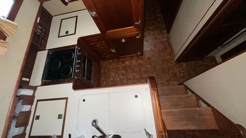 Slide: The Image of Interior of 1987 Grand Banks 46 Classic yacht, featuring a compact kitchen area. - 31