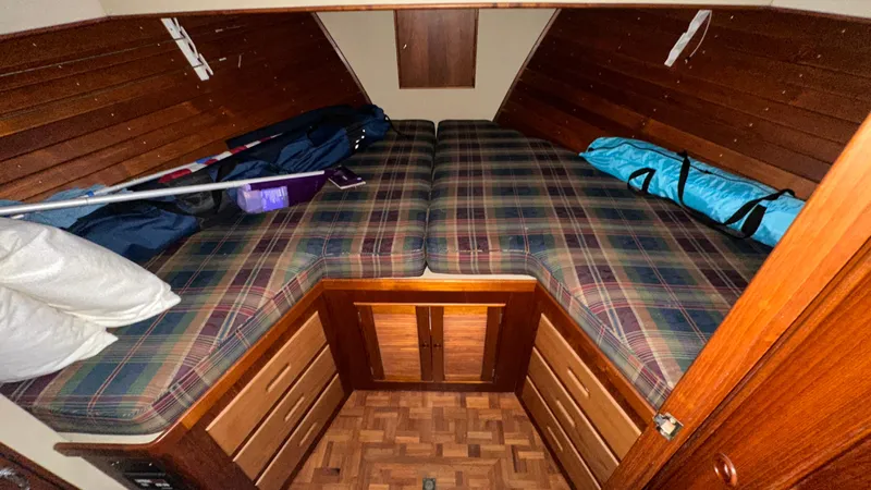 Slide: The Image of Cabin interior of 1987 Grand Banks 46 Classic with plaid bedding and wooden paneling. - 32