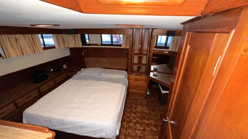 Slide: The Image of 1987 Grand Banks 46 Classic yacht bedroom with wood interior and double bed. - 33