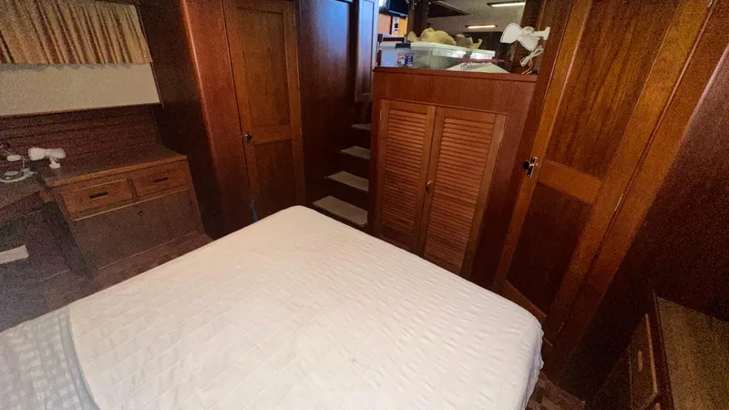 Slide: The Image of Interior of 1987 Grand Banks 46 Classic yacht with wooden cabinetry and bed. - 35