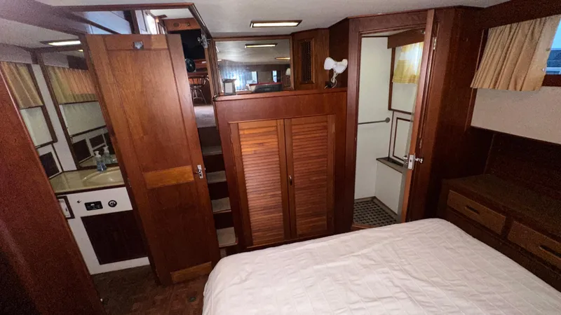 Slide: The Image of Interior of 1987 Grand Banks 46 Classic yacht, featuring wood paneling and cozy cabin space. - 36