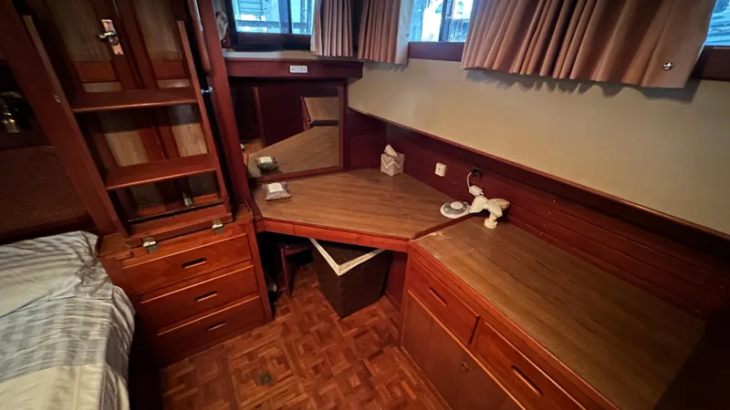 Slide: The Image of 1987 Grand Banks 46 Classic cabin interior with wooden desk and storage. - 38