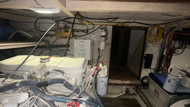 Slide: The Image of Engine room of a 1987 Grand Banks 46 Classic yacht, showcasing mechanical components and wiring. - 41