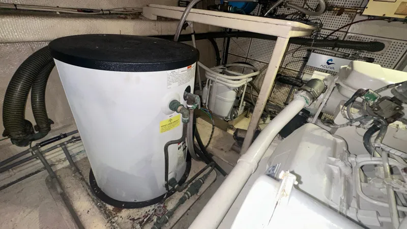 Slide: The Image of Engine room of 1987 Grand Banks 46 Classic yacht, featuring equipment and piping. - 42