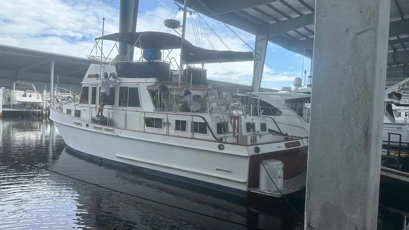 Slide: The Image of 1987 Grand Banks 46 Classic yacht docked in a covered marina. - 46