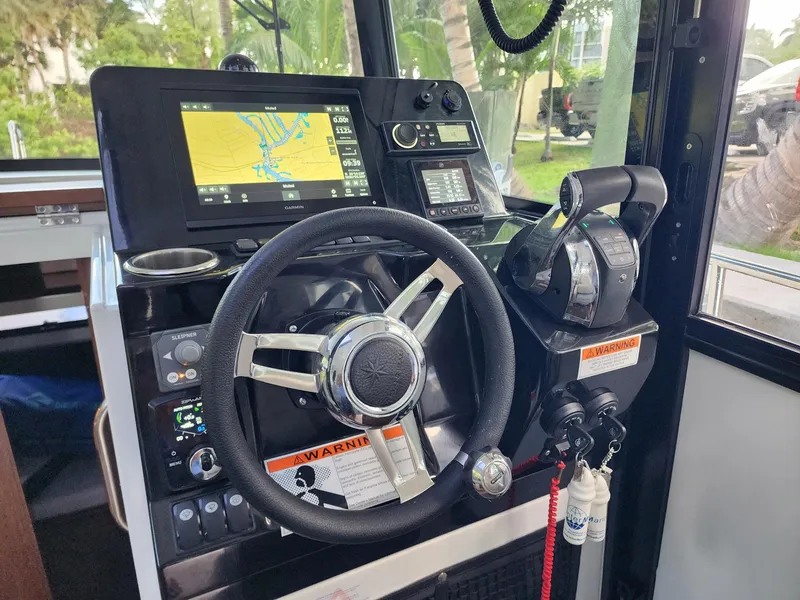 Slide: The Image of 2023 Jeanneau NC Sport 895 helm with navigation system and controls. - 12