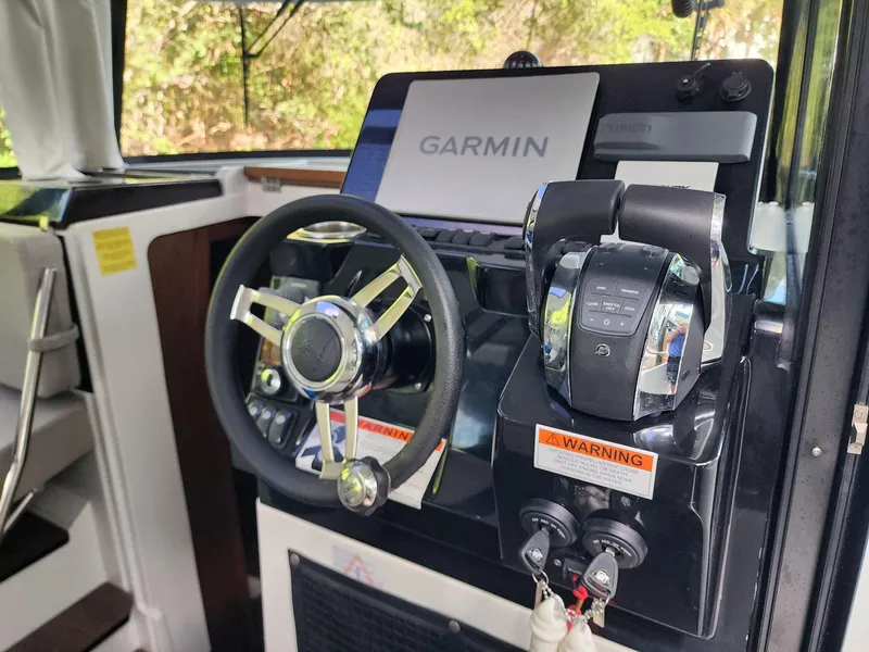 Slide: The Image of 2023 Jeanneau NC Sport 895 helm with Garmin navigation system and controls. - 13