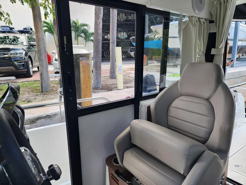 Slide: The Image of Interior of 2023 Jeanneau NC Sport 895 boat with comfortable seating and window view. - 14