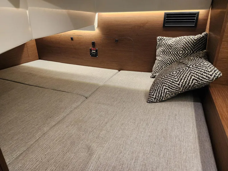 Slide: The Image of 2023 Jeanneau NC Sport 895 cabin interior with cozy bedding and cushions. - 24