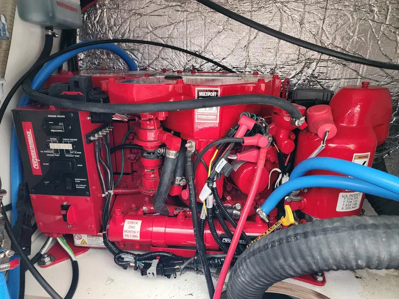 Slide: The Image of Engine compartment of 2023 Jeanneau NC Sport 895 with red machinery and wiring. - 25