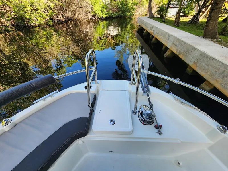Slide: The Image of 2023 Jeanneau NC Sport 895 boat docked by a serene canal. - 4