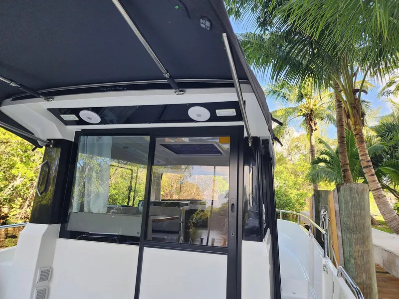 Slide: The Image of 2023 Jeanneau NC Sport 895 boat docked near palm trees. - 7