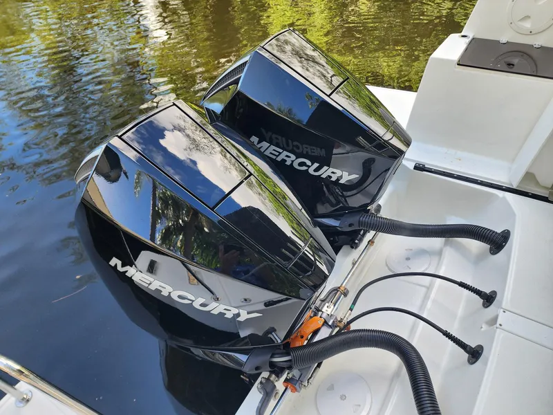 Slide: The Image of Twin Mercury outboard engines on a 2023 Jeanneau NC Sport 895 boat. - 8