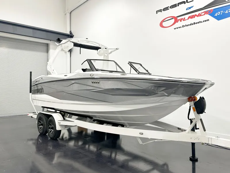 The Image of 2025 Centurion NV213 boat on trailer in showroom. - 1