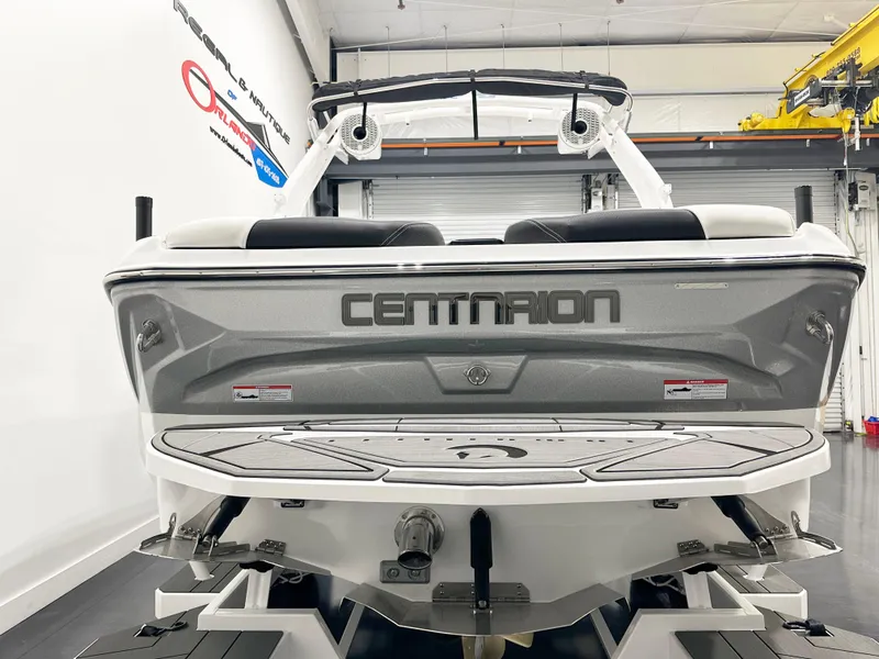 Slide: The Image of 2025 Centurion NV213 boat, rear view in a showroom setting. - 5