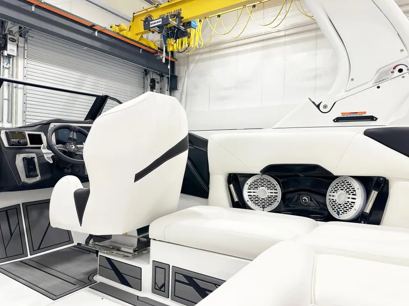 Slide: The Image of Interior of 2025 Centurion NV213 boat with white seating and modern dashboard. - 9