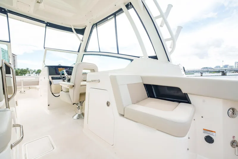 Slide: The Image of 2023 Boston Whaler 280 Vantage interior, featuring modern seating and helm design. - 28