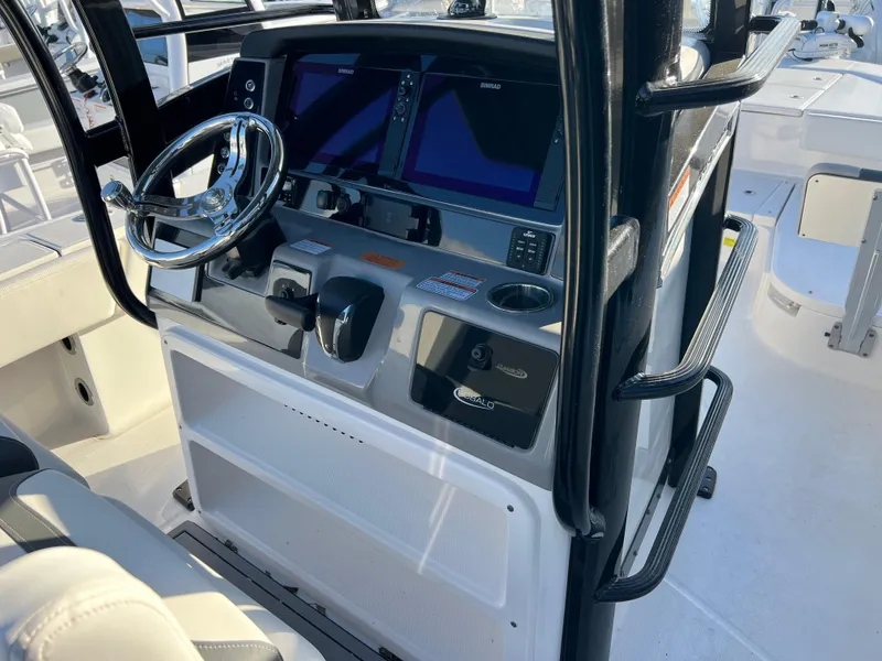 Slide: The Image of 2025 Robalo 266 Cayman SD boat dashboard with modern controls and dual screens. - 10