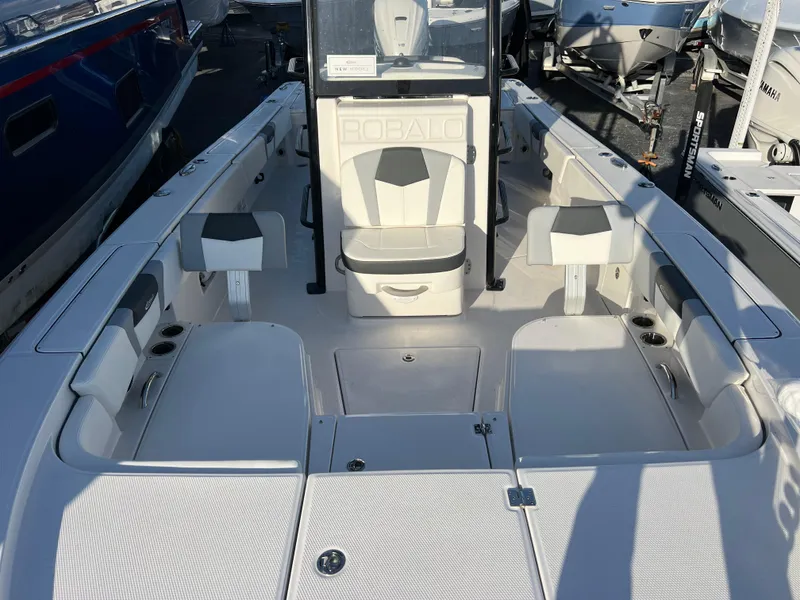 Slide: The Image of 2025 Robalo 266 Cayman SD boat interior with seating and storage compartments. - 13