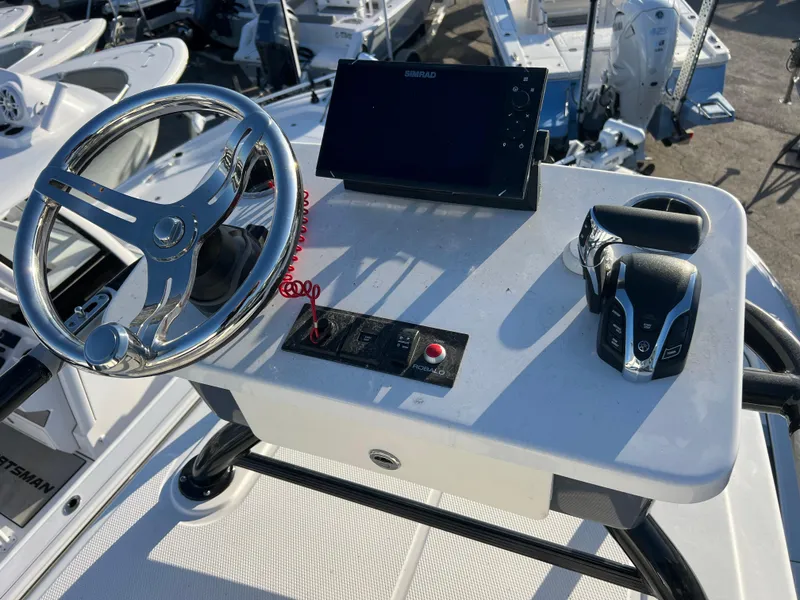 Slide: The Image of 2025 Robalo 266 Cayman SD helm with steering wheel and control panel. - 18