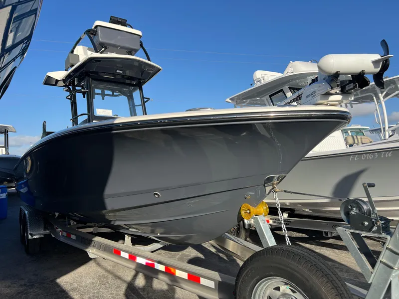 Slide: The Image of 2025 Robalo 266 Cayman SD boat on trailer, displayed outdoors. - 4