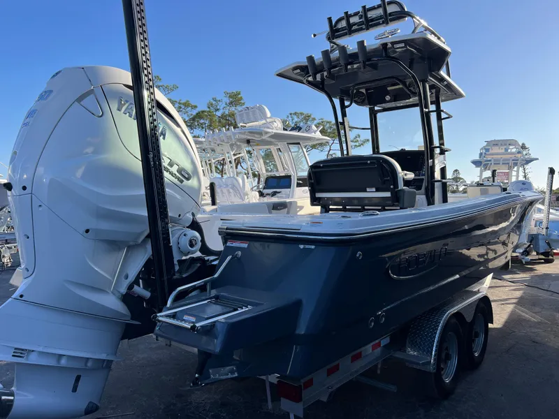 Slide: The Image of 2025 Robalo 266 Cayman SD boat on trailer, featuring powerful outboard motor. - 5