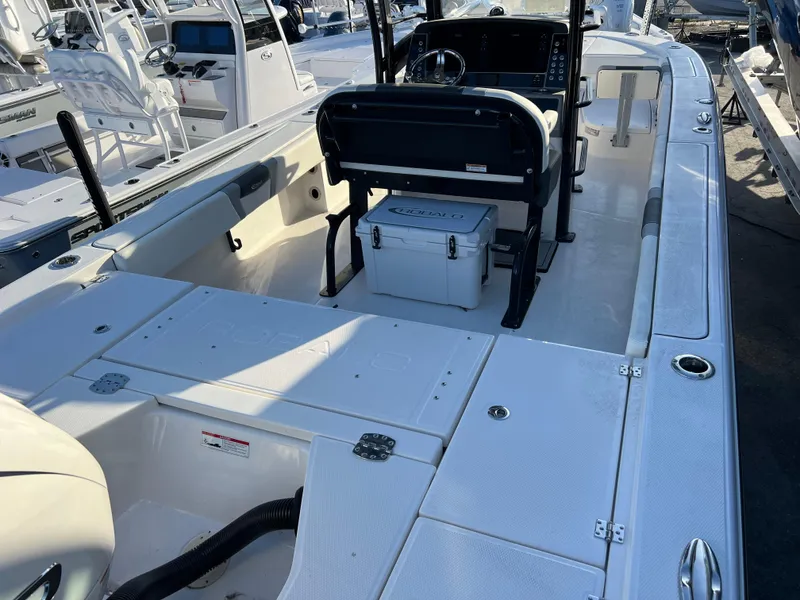 Slide: The Image of 2025 Robalo 266 Cayman SD boat interior with seating and console. - 7