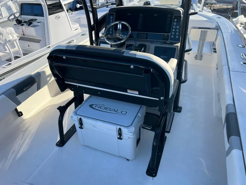 Slide: The Image of 2025 Robalo 266 Cayman SD boat interior with steering console and seating. - 8