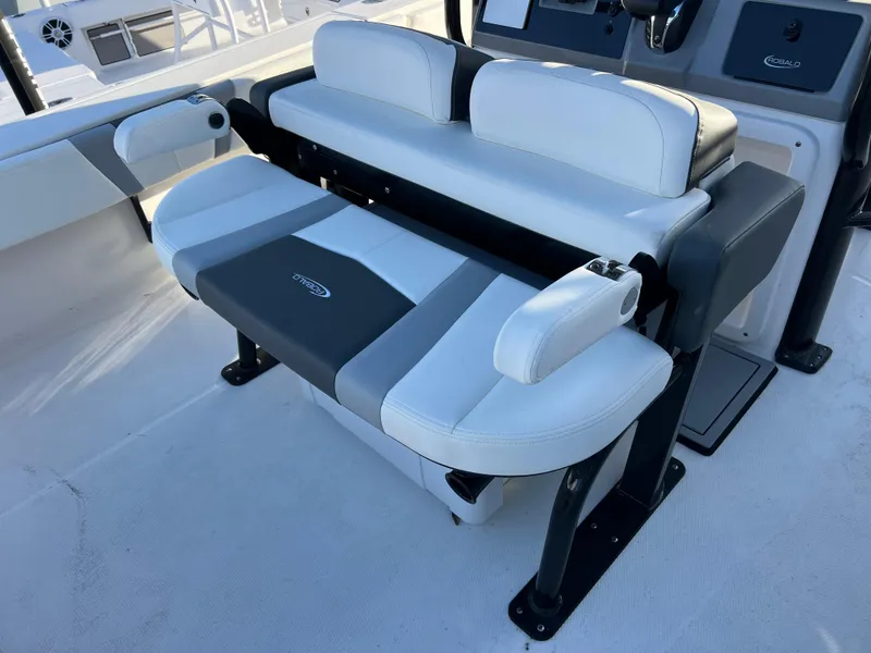 Slide: The Image of 2025 Robalo 266 Cayman SD boat seating with white and gray upholstery. - 9
