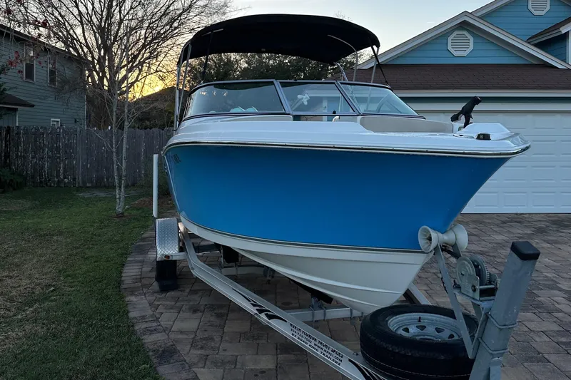 Slide: The Image of 2015 NauticStar 2000 XSDC boat on trailer, parked in driveway. - 1