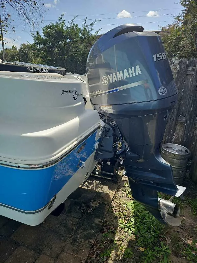 Slide: The Image of 2015 NauticStar 2000 XSDC boat with Yamaha 150 outboard motor, parked outdoors. - 12