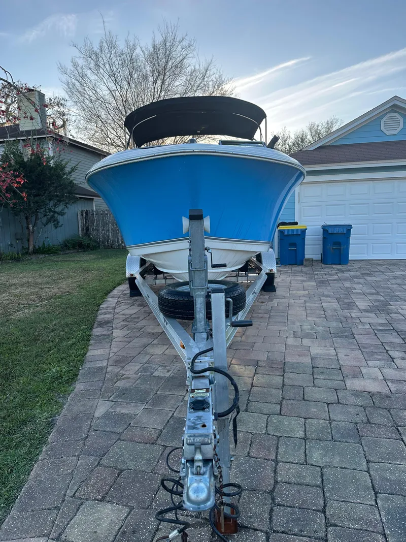 Slide: The Image of 2015 NauticStar 2000 XSDC boat on trailer in driveway, front view. - 14