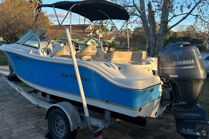 Slide: The Image of 2015 NauticStar 2000 XSDC boat with Yamaha engine on trailer. - 21