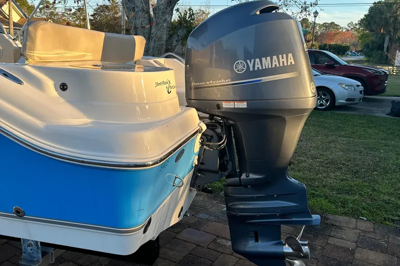 Slide: The Image of 2015 NauticStar 2000 XSDC boat with Yamaha outboard motor, parked on brick driveway. - 23